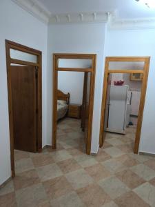 a room with two open doors and a kitchen at nayla y amira in Martil +1 photo