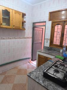 a kitchen with a counter and a stove in it at nayla y amira in Martil