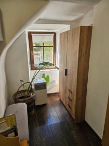 an attic room with a door and a window at Apartment Slavija in Škofja Loka