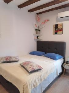 a bedroom with a large bed with blue pillows at D & G in Split