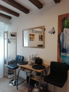 a room with a table and chairs and a mirror at D & G in Split +3 photos