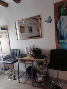 a table and chairs in a room with a mirror at D & G in Split