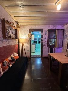 a room with a couch and a table and a door at Uai hostel in Ouro Preto