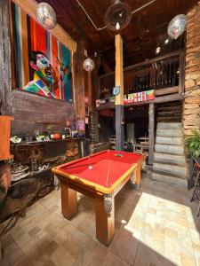 a pool table in the middle of a room at Uai hostel in Ouro Preto
