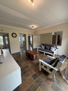 a living room with a couch and a table at Cornerstone on Livingstone in Vryburg