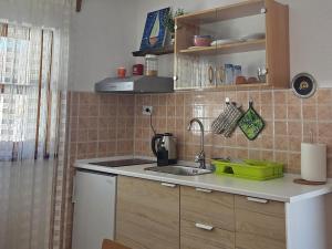 a kitchen with a sink and a counter top at Cozy Bungalow Stipe in Plitvička Jezera