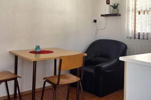 a chair and a table in a kitchen with a chair and a table at Cozy Bungalow Stipe in Plitvička Jezera