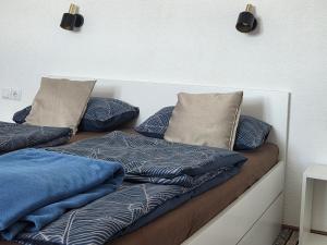 two pillows sitting on a bed in a room at Cozy Bungalow Stipe in Plitvička Jezera