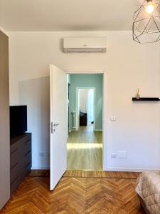a bedroom with a door open to a room at AlexBnB in Turin