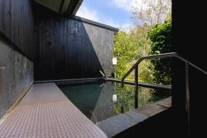 a house with a plunge pool with a metal railing at 霧島花紫 in Kirishima +24 photos