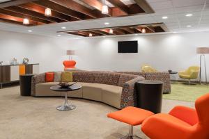 a lobby with a couch and a table and chairs at EVEN Hotel Ann Arbor S - University Area by IHG in Ann Arbor