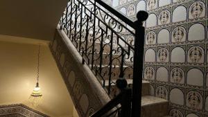 a stairway with a wrought iron railing and a light at Tidmi Wave Anza in Agadir +35 photos
