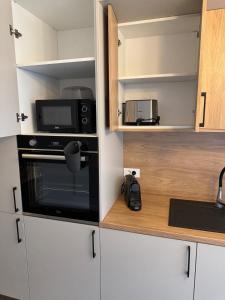 a kitchen with a microwave and a stove at Nordic Star in Rădăuţi +16 photos