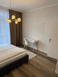 a bedroom with a bed and a desk with a chair at Nordic Star in Rădăuţi