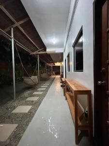 a room with benches and a table and a building at Dodong homestay 2 in General Luna