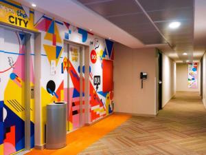 a hallway of an office with a colorful wall at ibis Budget Bogota Marly in Bogotá