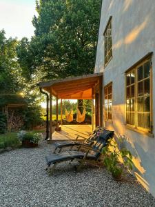 two lounge chairs sitting outside of a house at Designed House With Recycled Details In Österlen in Köpingebro