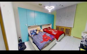 a bedroom with a bed with a teddy bear on it at private room in Seveso +1 photo