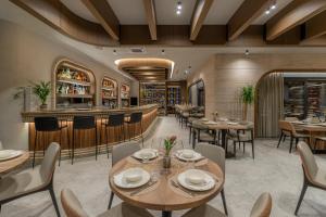 a restaurant with tables and chairs and a bar at Central Hotel in Ferizaj