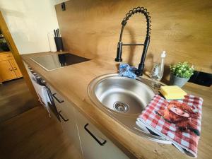 a kitchen counter with a sink in a kitchen at Christines Ferienwohnung in Weiler-Simmerberg +15 photos