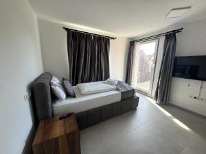 a living room with a couch and a large window at AS Aparthotel in Schorndorf