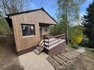 a tiny house with a deck and stairs at Lépcsősház in Nagymaros +13 photos