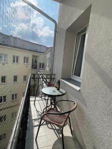 a balcony with tables and chairs and a window at Central Comfort Studio Walkup in Slezská Ostrava