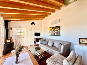 a living room with a couch and a table at Marvão Country Houses - Queixos I in Santo António das Areias
