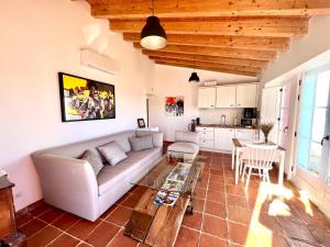 a living room with a couch and a table at Marvão Country Houses - Queixos I in Santo António das Areias