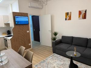 a living room with a couch and a table at AlexBnB in Turin