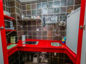 a small kitchen with a red counter and a sink at Apartamento CENTRO HISTÓRICO Zorrilla 4 in Zamora +1 photo