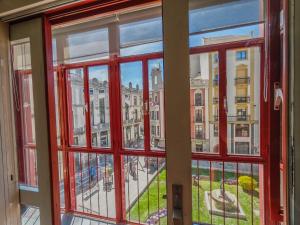 a window with a view of a city seen through it at Apartamento CENTRO HISTÓRICO Zorrilla 4 in Zamora