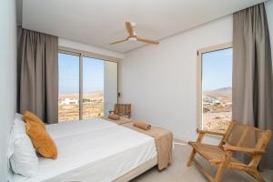 a bedroom with a bed and a large window at Villa James by Aura Collection in Tindaya