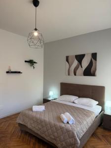 a bedroom with a bed with two towels on it at AlexBnB in Turin