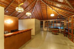 a lobby with a bar and a dining room at Vynza Resort Vythiri in Vythiri