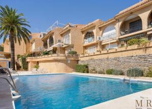 a swimming pool in front of a building at Casa Eva Ref #97 in Estepona