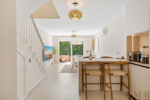 a kitchen with white walls and a table and chairs at Casa Eva Ref #97 in Estepona