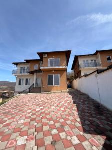 a house with a brick driveway in front of it at Prestige Deluxe View Villa in Ilijaš