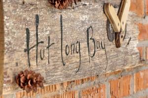 a sign on a brick wall with a clock on it at Little hut in Kampong Kundassan