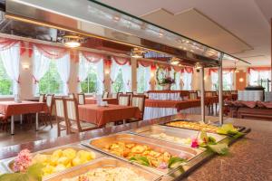 a buffet in a restaurant with a lot of food at Bałtyk Resort in Rewal