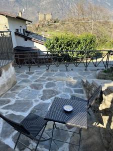 a table and chairs sitting on a stone patio at Pres du Chateau in Châtillon