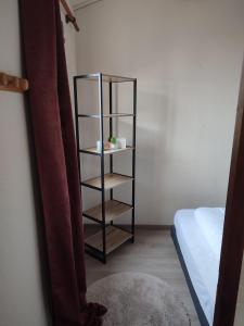 a black book shelf in a room with a bed at Appt climatisé vues sur mer in Fleury +18 photos