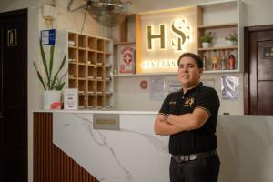 a man standing in a store with his arms crossed at Hotel San Francisco in Tarapoto