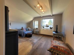 a living room with a couch and a window at Ferienhaus Heilhecker in Brake