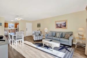 a living room with a couch and a table at Lighthouse Point Rental 8B in Tybee Island