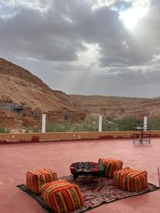a group of chairs sitting on top of a patio at Pergolas Tamakouchte in Ouarzazate +16 photos