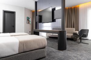 a hotel room with a bed and a flat screen tv at Central Hotel in Ferizaj +45 photos
