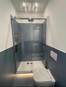 a bathroom with a glass shower with a toilet at Exclusive tra mare e centro in Genoa