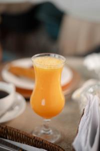 a glass of orange juice sitting on a table at Hotel San Francisco in Tarapoto