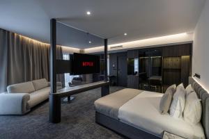 a hotel room with a bed and a tv at Central Hotel in Ferizaj